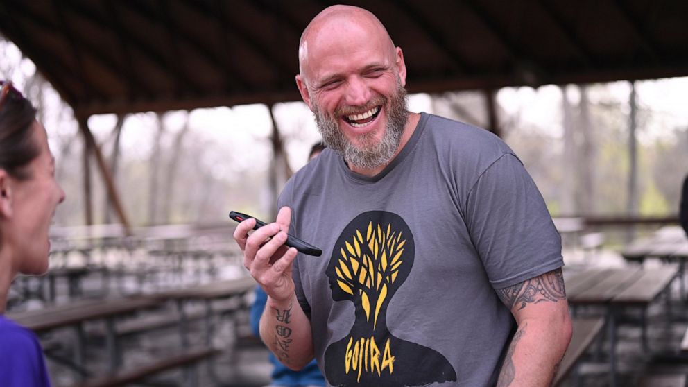 In this photo provided by courtesy of the MacArthur Justice Center, Michael Politte smiles after being released on parole on Friday, April 22, 2022, at the Jefferson City Correctional Center in Jefferson City, Mo. He has been behind bars for nearly t