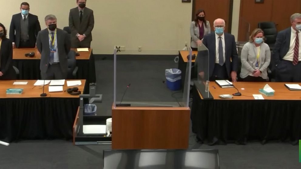 In this image taken from video, the prosecution, left, and the defense, right, stand, as the jury enters the courtroom to deliver a question to Hennepin County Judge Regina Chu, during deliberations Tuesday, Dec. 21, 2021, in former Brooklyn Center p
