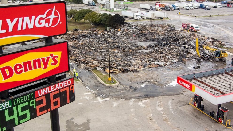 The remains of a combined Denny's restaurant and Pilot Flying J Travel Center near Interstate 10 are seen on Thursday, Dec. 1, 2022, after a morning fire destroyed the building in San Antonio. (William Luther/The San Antonio Express-News via AP)