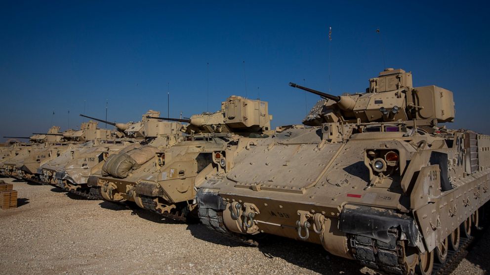 FILE - In this Nov. 11, 2019, file photo, Bradley fighting vehicles are parked at a U.S. military base at an undisclosed location in Northeastern Syria, Monday, Nov. 11, 2019. The U.S. has deployed additional troops and armored vehicles into eastern 
