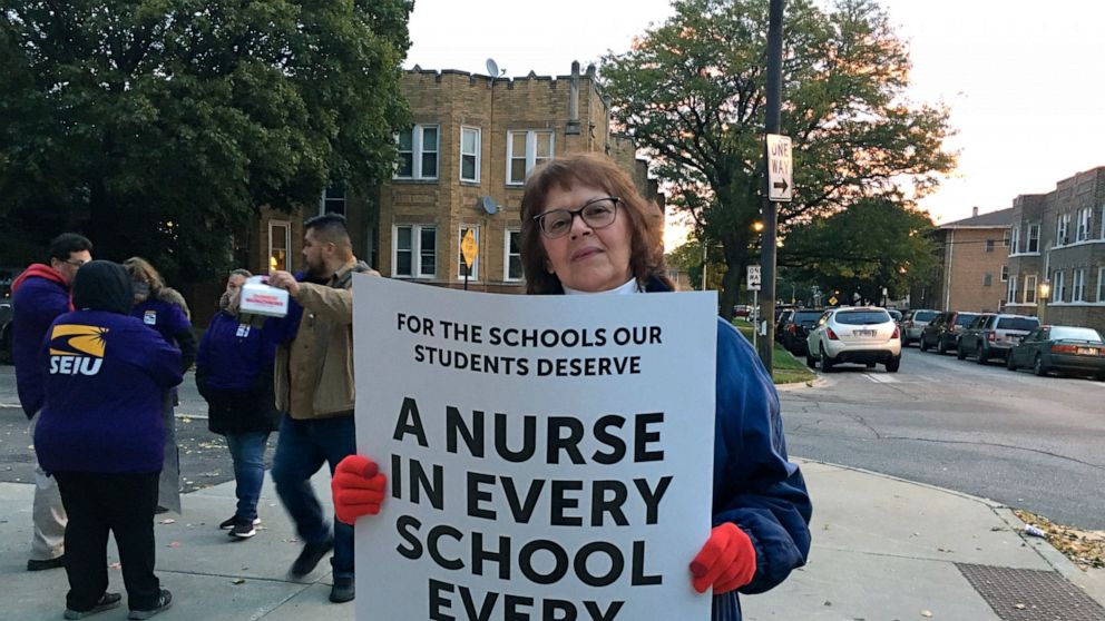 Third grade teacher Gay Niemeier pickets outside Sawyer Elementary School in Chicago, Thursday, Oct. 17, 2019, on the first day of a teacher's strike. Chicago teachers went on strike Thursday after failing to reach a contract deal with the nation's t
