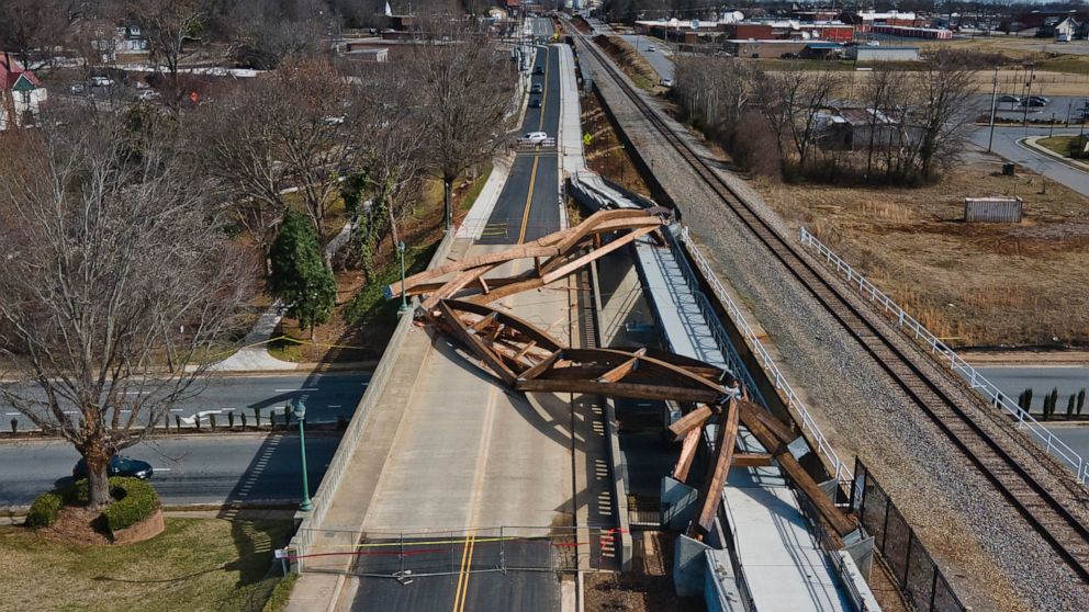FILE - This aerial image taken with a drone, shows collapsed wooden arches Friday morning, Feb. 18, 2022, in Hickory. N.C. The North Carolina city is suing three companies over the collapse of decorative, 40-ton wooden arches along a pedestrian walkw