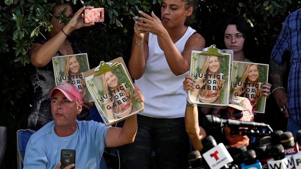 Supporters of Gabby Petito hold up photos of Gabby after a news conference Wednesday, Oct. 20, 2021, in North Port, Fla. Items believed to belong to Brian Laundrie and potential human remains were found in a Florida wilderness park during a search fo