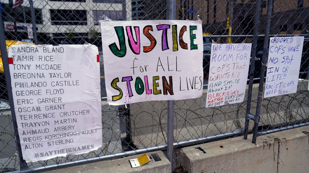 New signs are on a fence at the Hennepin County Government Center, Monday, April 19, 2021, in Minneapolis where closing arguments are being heard in the trial of former Minneapolis police officer Derek Chauvin continues. Chauvin is charged with murde