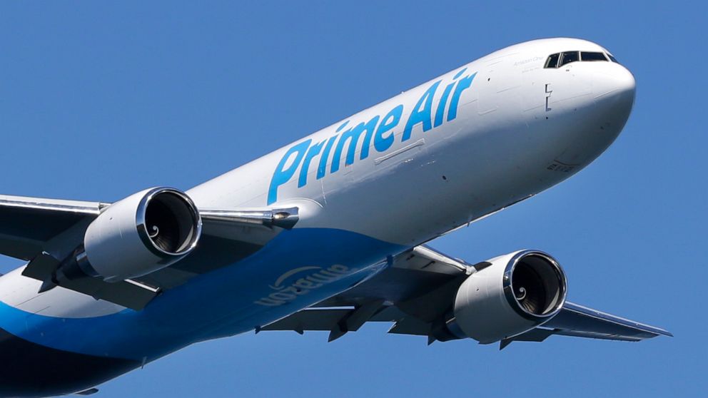 FILE - In this Friday, Aug. 5, 2016, file photo, a Boeing 767 with an Amazon.com "Prime Air" livery flies over Lake Washington, as part of the Boeing Seafair Air Show. Amazon said Wednesday, June 30, 2021, that its carbon footprint grew 19% last year