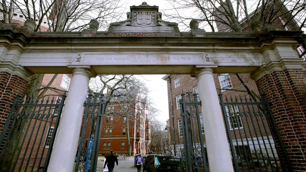 FILE - In this Dec. 13, 2018, file photo, a gate opens to the Harvard University campus in Cambridge, Mass. Harvard President Lawrence Bacow announced Tuesday, April 26, 2022 that the university is committing $100 million to study its ties to slavery
