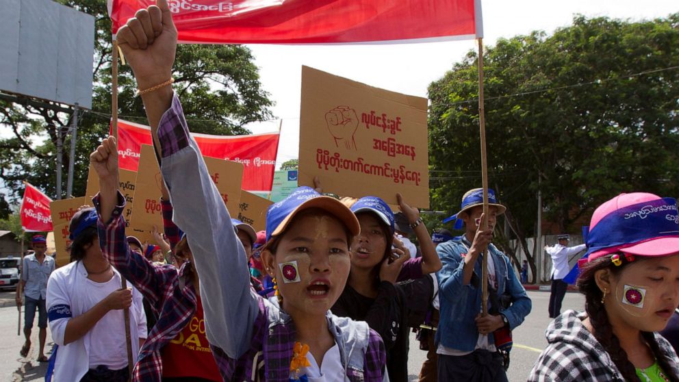 FILE - In this May 1, 2018, file photo, Myanmar workers, mostly from garment and shoe factories, take part in a May Day march in Yangon, Myanmar. Garment workers in Myanmar are urging major international brands to denounce the recent military coup th