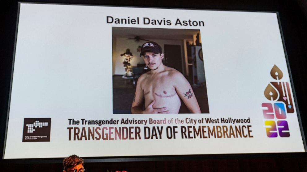 Musician Ryan Cassata reads the name of 28-year-old victim Daniel Davis Aston, a bartender killed at Club Q in Colorado Springs, Colo., at the Transgender Day of Remembrance event in West Hollywood, Calif., Sunday night, Nov. 20, 2022. (AP Photo/Dami