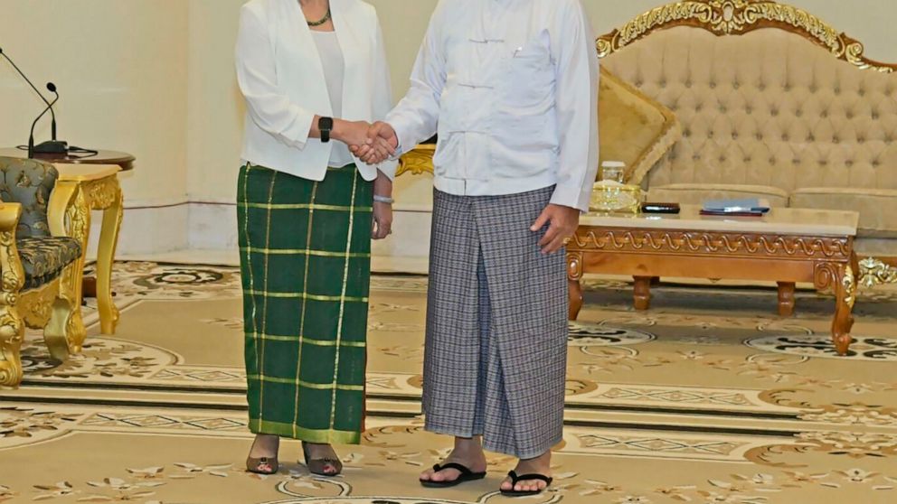 In this image provided by the Military True News Information Team, United Nations special envoy Noeleen Heyzer, left, and State Administration Council Chairman Senior Gen. Min Aung Hlaing shake hands Wednesday, Aug. 17, 2022, in Naypyitaw, Myanmar. H