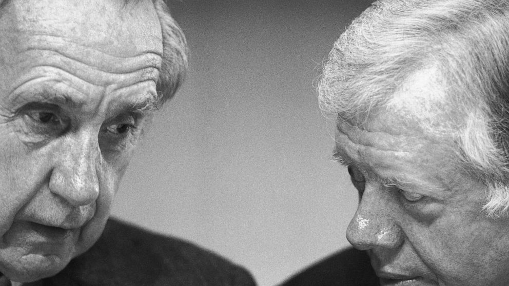 FILE - In this Nov. 17, 1987 file photo, Sir Brian Urquhart, former under secretary-general of the United Nations, left, and former President Jimmy Carter confer during the opening session of a Middle East conference held at the Carter Center in Atla