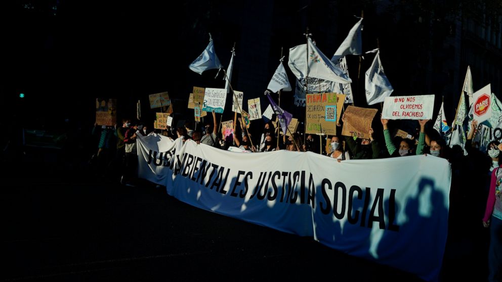 FILE - People march holding a banner with a message that reads in Spanish; "Environmental justice is social justice" during a global climate strike demonstration in Buenos Aires, Argentina, Sept. 24, 2021. Philanthropy can fight climate change more e