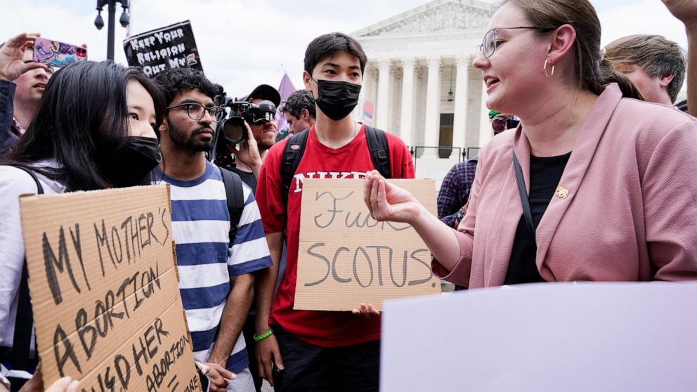 Abortion-rights activists, at left, confront anti-abortion activists, at right, react following Supreme Court's decision to overturn Roe v. Wade in Washington, Friday, June 24, 2022. The Supreme Court has ended constitutional protections for abortion