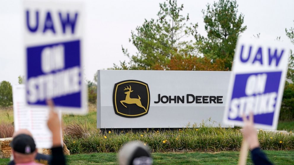 FILE - Members of the United Auto Workers strike outside of a John Deere plant, Wednesday, Oct. 20, 2021, in Ankeny, Iowa. The farm equipment manufacturer reached a tentative labor agreement Saturday, Oct. 30, with the United Auto Workers union. But 