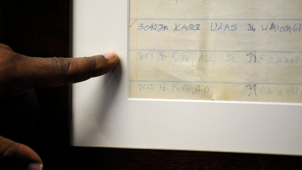 In this Friday, Jan. 10, 2020 photo, Jefferson County Sheriff Mark Pettway points out an old jail log showing the name of Dr. Martin Luther King Jr. in Birmingham, Ala. The county is taking steps to preserve the old county jail, where officials say K