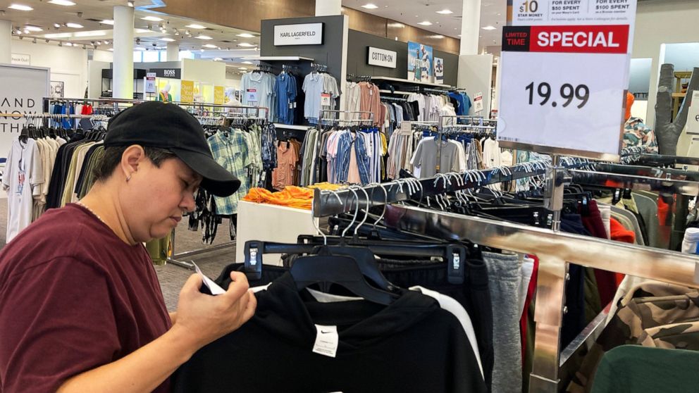 A customer checks price tags as she shops at a retail store in Schaumburg, Ill., Thursday, June 30, 2022. (AP Photo/Nam Y. Huh)