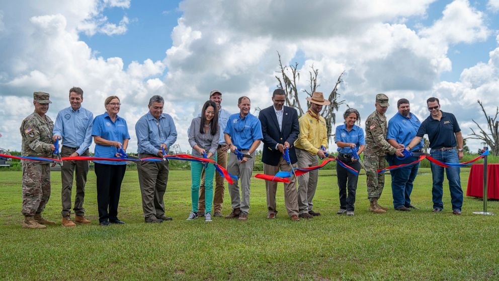 This photo provided by U.S. Army Corps of Engineers shows a ribbon cutting ceremony at at Riverwoods Field Laboratory in Lorida, Fla,, on Thursday, July 29, 2021. State and federal officials in Florida are marking a major milestone in a 22-year proje
