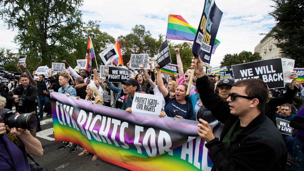 FILE - In this Oct. 8, 2019, photo, supporters of LGBTQ rights stage a protest on the street in front of the U.S. Supreme Court in Washington. A judge in Tennessee on Friday, July 15, 2022, has temporarily barred two federal agencies from enforcing d