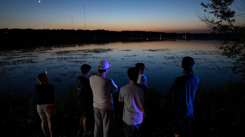 Friends and family gathered at Vadnais Lake after news of a dead child being pulled out of the lake broke, Friday, July 1, 2022 in Vadnais Heights, Minn. The bodies of two young children have been recovered from the Minnesota lake, and searchers are 