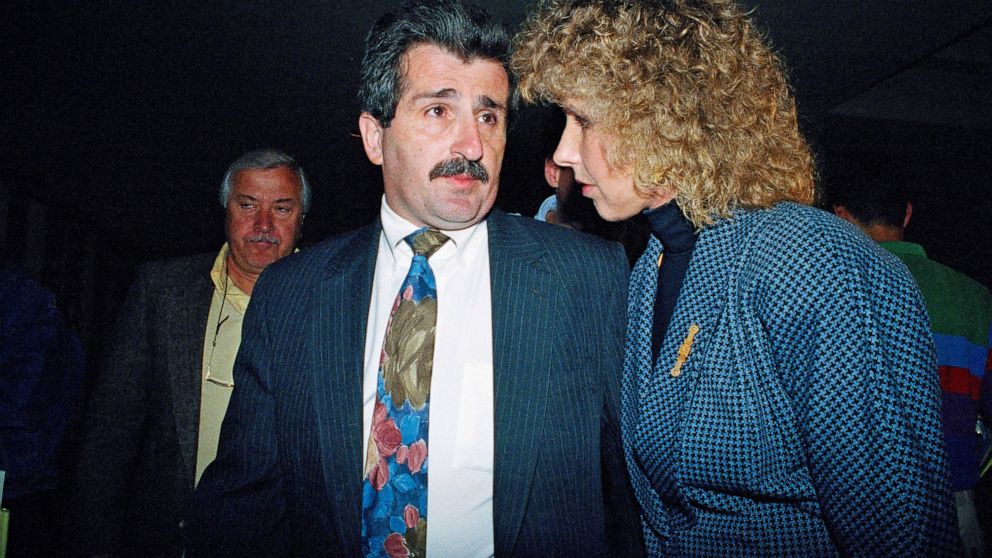 FILE — In this May 27, 1992 file photo, Paul Solomon, center, talks with an unidentified friend as he leaves Westchester County Courthouse in White Plains, N.Y., after a jury found his former lover Carolyn Warmus, guilty of killing his wife in Januar