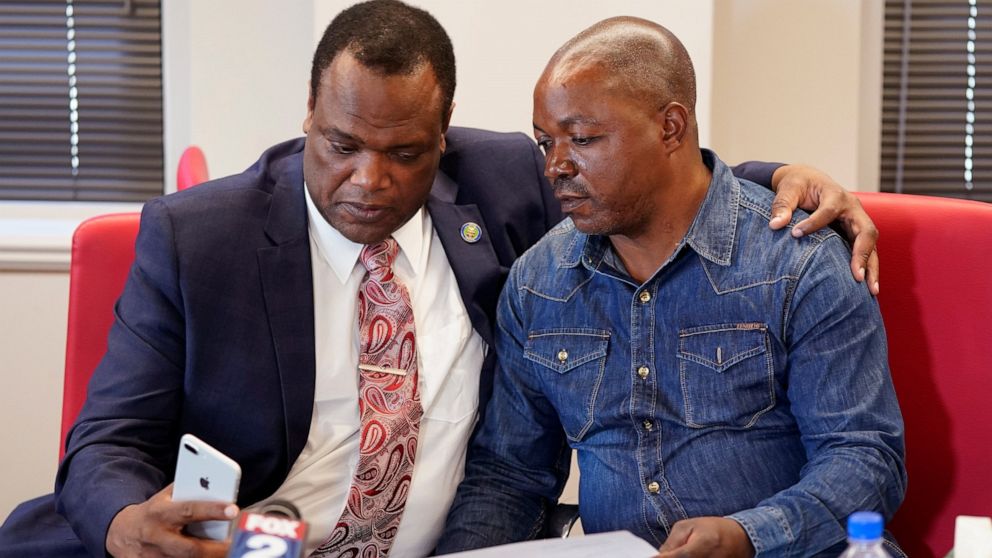 Kent County Commissioner Robert Womack shows Peter Lyoya the broadcast feed in attorney Ven Johnson's office, Thursday, June 9, 2022, in Detroit. A Michigan police officer who killed Peter's son, Patrick Lyoya, with a shot to the back of the Black ma