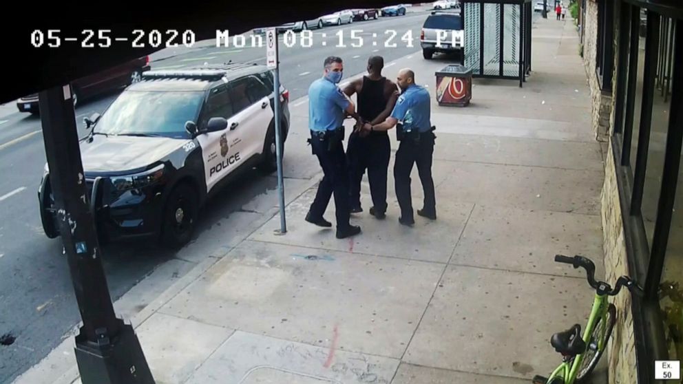 FILE - This image from video shows Minneapolis police Officers Thomas Lane, left and J. Alexander Kueng, right, escorting George Floyd, center, to a police vehicle outside Cup Foods in Minneapolis, on May 25, 2020. Three former Minneapolis officers h