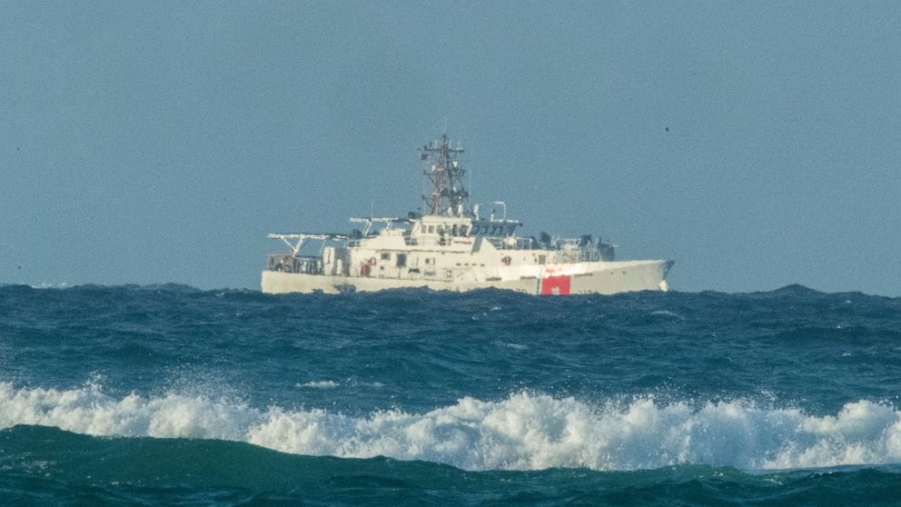A U.S. Coast Guard cutter patrols the area of debris from a 737 cargo plane that crashed off Oahu, Friday, July 2, 2021, near Honolulu. The plane made an emergency landing in the Pacific Ocean off the coast of Hawaii early Friday and both people on b