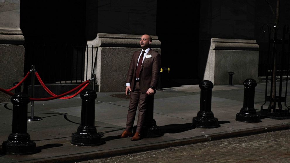 A market trader takes a break outside of the New York Stock Exchange on Monday, March 9, 2020, in New York. Stocks went into a steep slide Monday on Wall Street as coronavirus fears and a crash in oil prices spread alarm through the market, triggerin