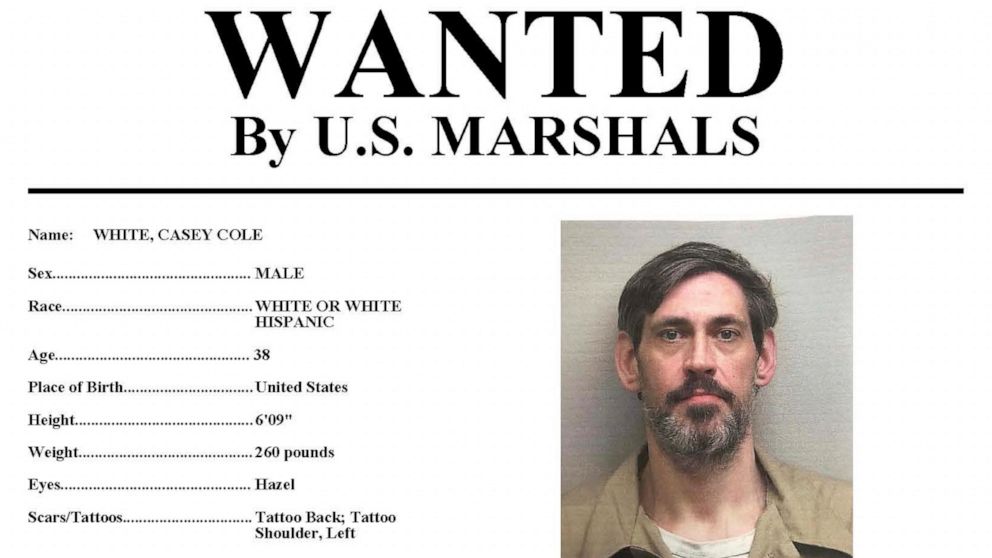 This image provided by the U.S. Marshals Service on Sunday, May 1, 2022 shows part of a wanted poster for Casey Cole White. On Sunday, the U.S. Marshals announced it is offering up to $10,000 for information about escaped inmate Casey Cole White, 38,