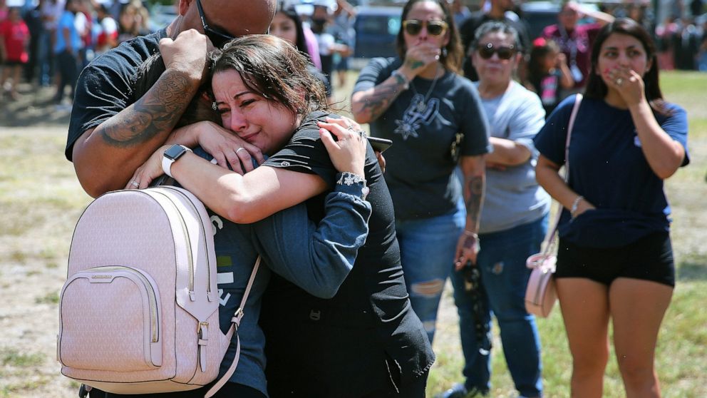 A family shares a tearful reunion following a chaotic scene outside of Thomas Jefferson High School in San Antonio, after the school went into lockdown on Tuesday, Sept. 20, 2022. Alarmed parents laid siege to the Texas high school Tuesday after a cl