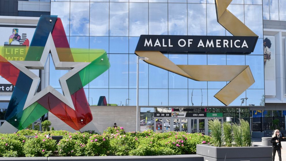 FILE - A visitor leaves the Mall of America, Thursday, June 11, 2020 in Bloomington, Minnesota. The mall reopened Wednesday after being closed since March due to the coronavirus. Police in Minnesota say the Mall of America has been placed on lockdown