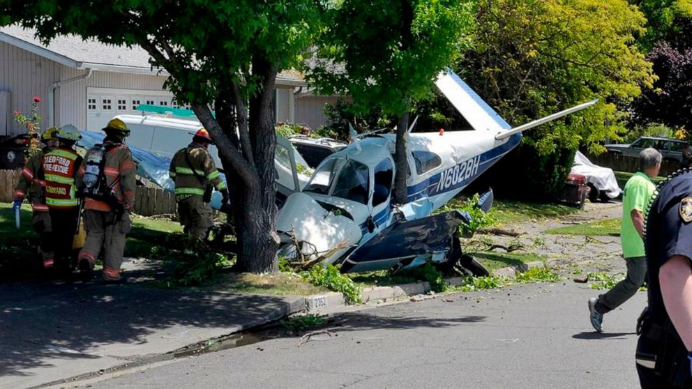 First responders work the scene of a plane crash, Saturday, June 8, 2019 in Medford, Ore. Authorities say the pilot and a passenger were injured after a small plane has crashed in Medford. (Andy Atkinson/The Medford Mail Tribune via AP)