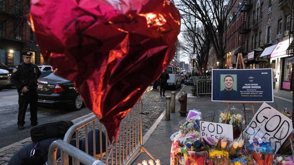 A makeshift memorial is seen outside the New York City Police Department's 32nd Precinct, near the scene of a shooting days earlier in the Harlem neighborhood of New York, Monday Jan. 24, 2022. (AP Photo/Yuki Iwamura)