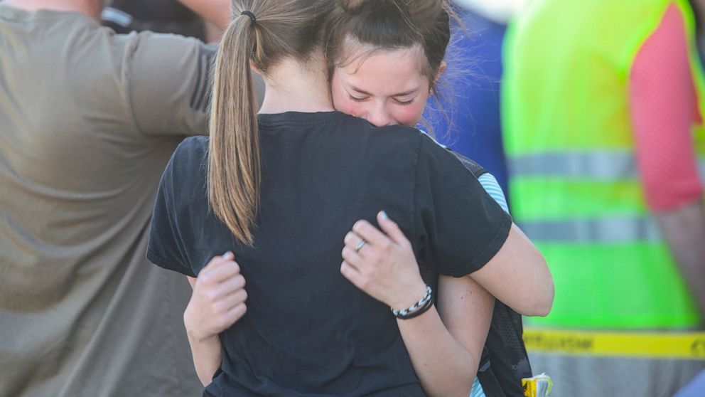 Students embrace after a school shooting at Rigby Middle School in Rigby, Idaho on Thursday, May 6, 2021. Authorities say a shooting at the eastern Idaho middle school has injured two students and a custodian, and a male student has been taken into c