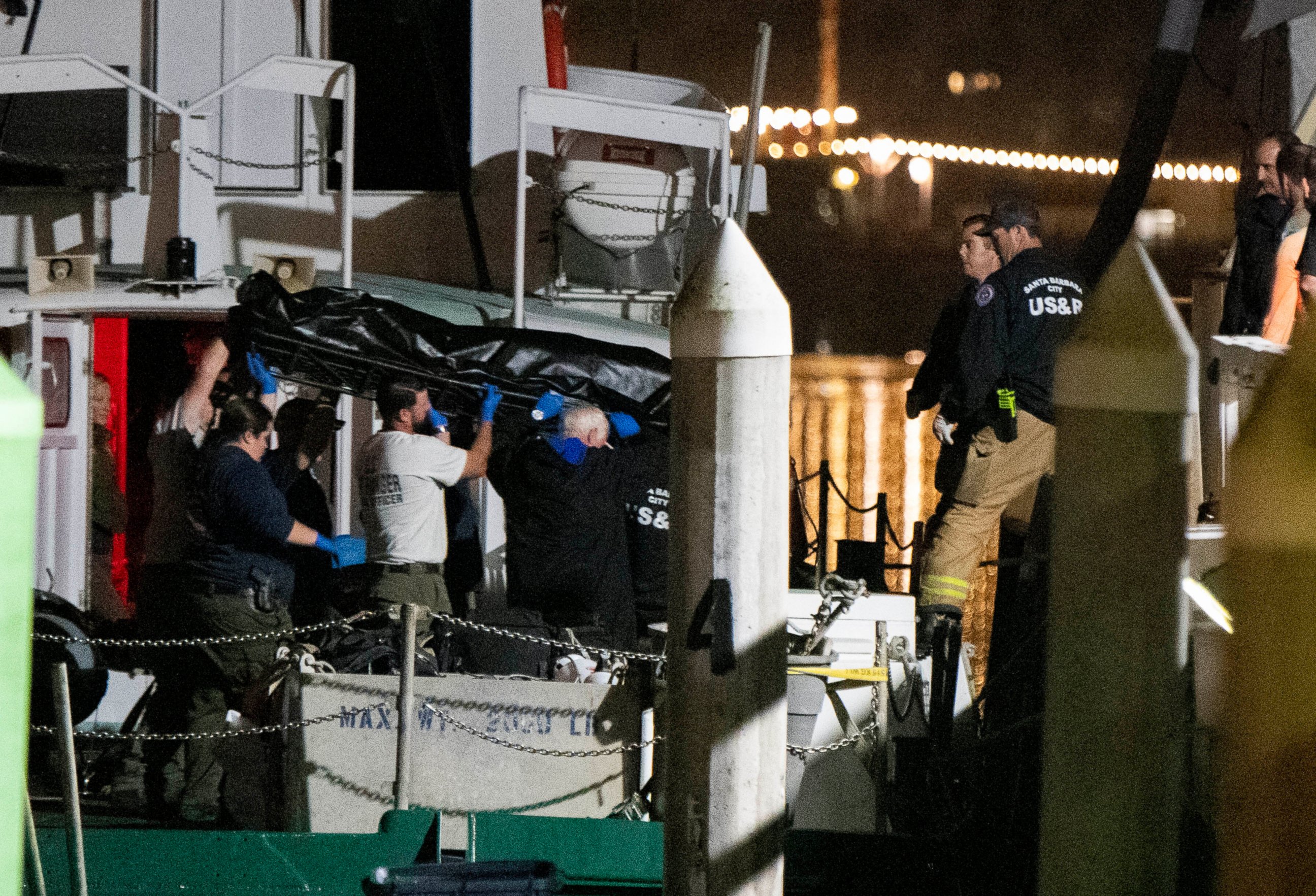 Local law enforcement along with search and rescue teams help unload the bodies of those who died in a diving boat fire, Monday, Sept. 2, 2019, in Santa Barbara, Calif. A fire raged through a boat carrying recreational scuba divers anchored near an i