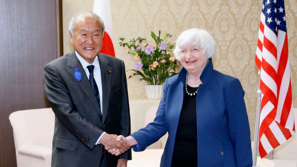 U.S. Treasury Secretary Janet Yellen, right, and Japan's Finance Minister Shunichi Suzuki shake hands during their meeting at the finance ministry in Tokyo, Tuesday, July 12, 2022. Yellen said Tuesday collaboration with Japan was pivotal for the war 