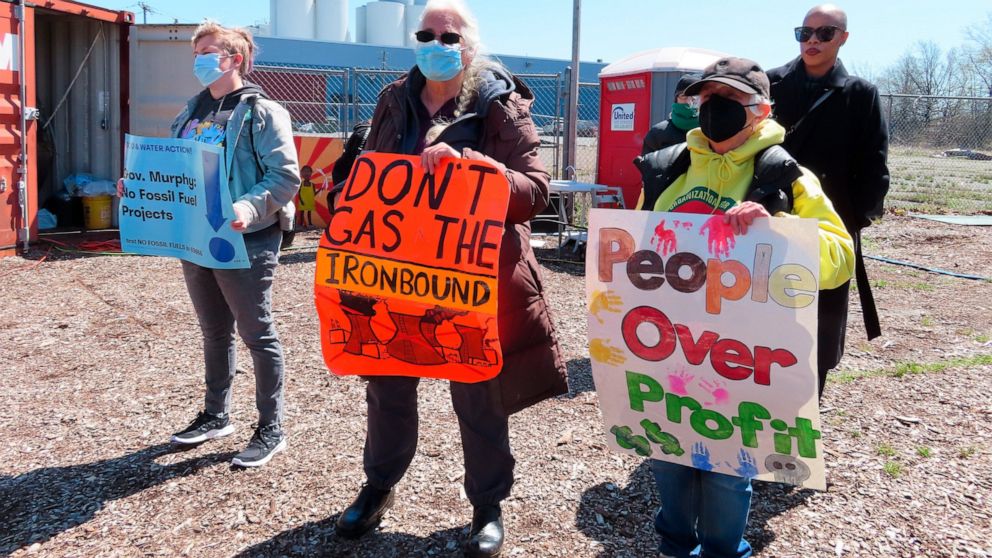 FILE - In this April 20, 2022 file photo, activists attend a protest against a proposed backup power plant for a sewage treatment facility in Newark N.J. The Passaic Valley Sewerage Commission is pushing forward with the gas-fired power plant just mo