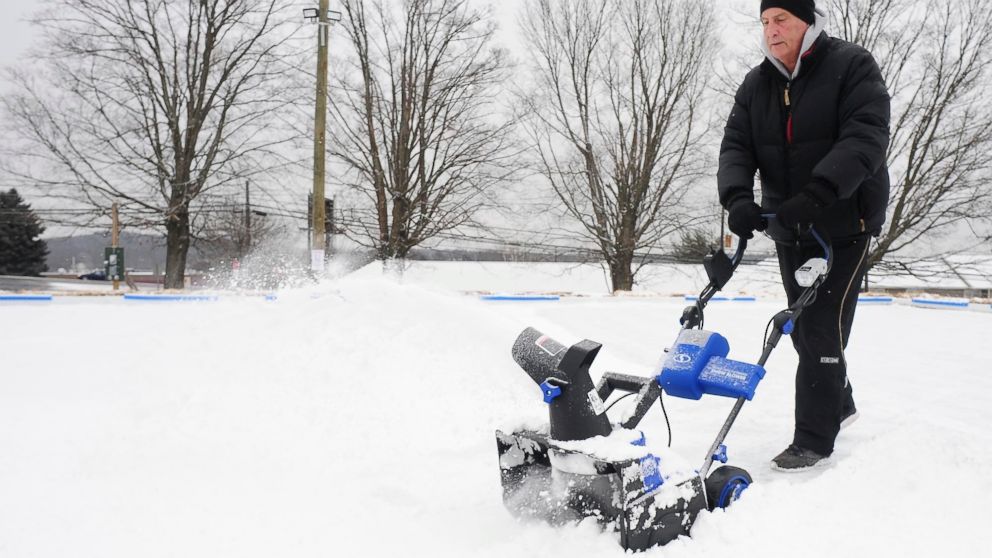 Former Wilkes Barre Scranton Penguins (AHL) head coach Glenn Patrick, uses a snow thrower to clear snow off a new ice skating rink in Dallas, Pa., Friday Jan. 18, 2019. (Mark Moran/The Citizens' Voice via AP)