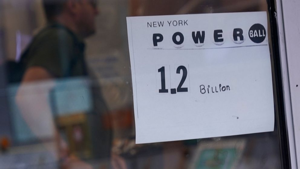 A sign on a convenience store advertises the Powerball lottery in New York, Tuesday, Nov. 1, 2022. The jackpot climbed to $1.2 billion after no one matched all six numbers to win the jackpot. (AP Photo/Seth Wenig)