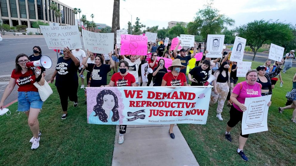 FILE - Thousands of protesters march around the Arizona Capitol in protest after the Supreme Court decision to overturn the landmark Roe v. Wade abortion decision Friday, June 24, 2022, in Phoenix. The U.S. Supreme Court ruling overturning Roe v. Wad