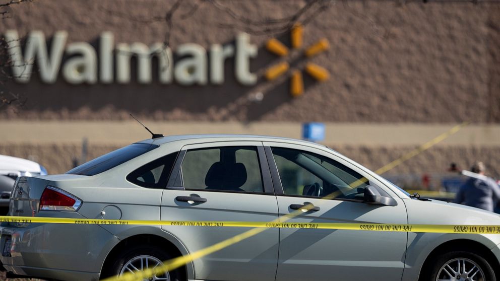 Crime scene tape surrounds a car at the scene of a mass shooting at a Walmart, Wednesday, Nov. 23, 2022, in Chesapeake, Va. A Walmart manager opened fire on fellow employees in the break room of the Virginia store, killing several people in the count