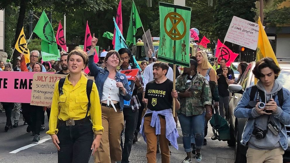 In this photo taken June 21, 2019, people demonstrating to raise awareness of climate change blocked streets in downtown Portland, Ore. The divide in Oregon between the state’s liberal, urban population centers and its conservative and economically d