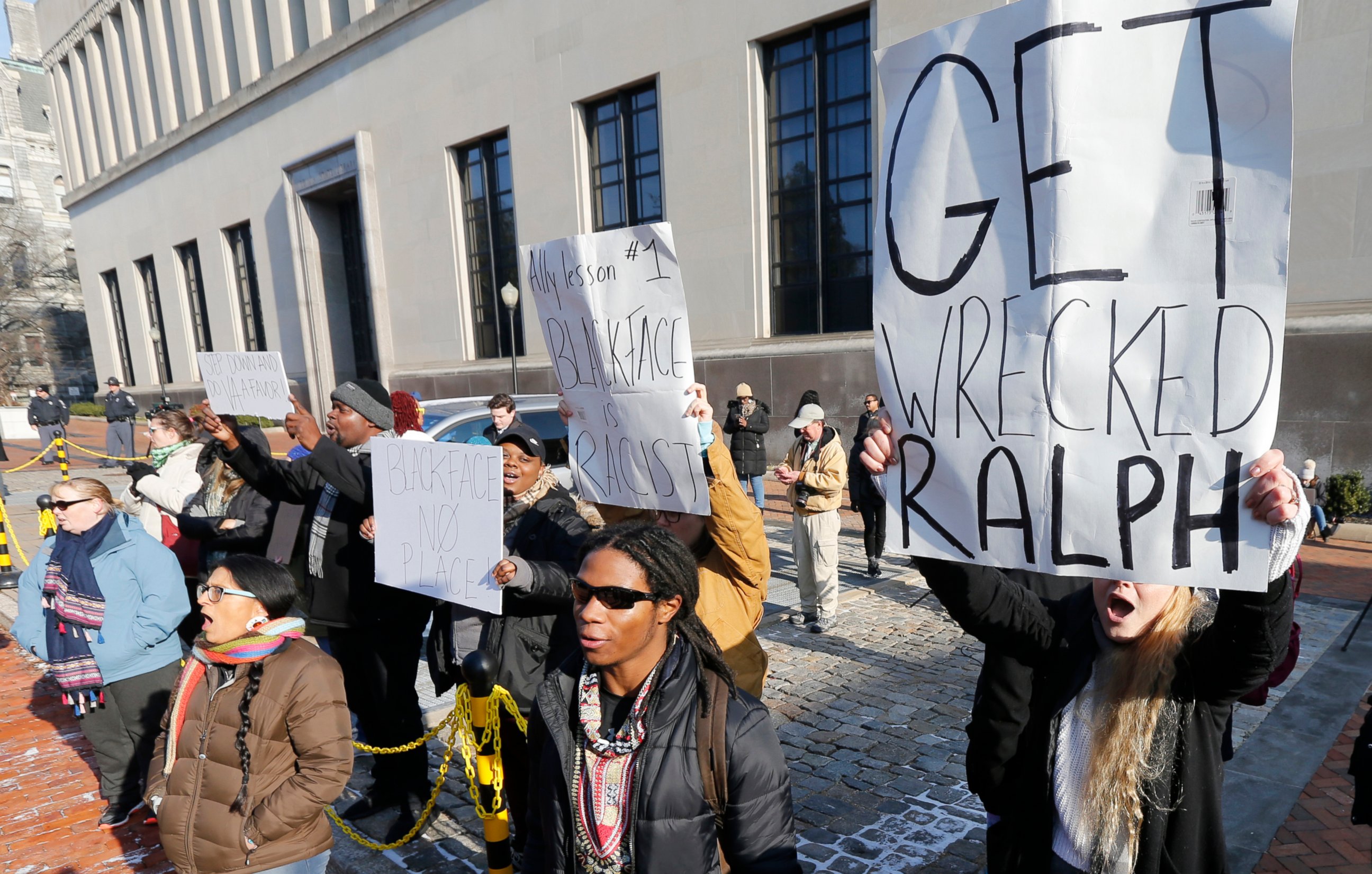 Demonstrators hold signs and chant outside the Governors office at the Capitol in Richmond, Va., Saturday, Feb. 2, 2019. The demonstrators are calling for the resignation of Virginia Governor Ralph Northam after a 30 year old photo of him on his medi