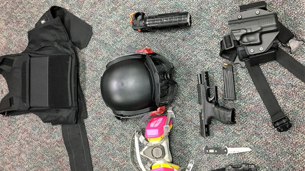 This Friday, March 12, 2021, photo released by Portland Police Bureau shows numerous items left behind by people inside the perimeter of a march, including a crowbar, hammers, bear spray, slugging weapon with rocks, high impact slingshot, and knives,