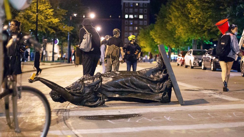 FILE - In this June 23, 2020 file photo, Wisconsin's "Forward" statue lies in the street on Capitol Square in Madison, Wis. Crowds outside the Wisconsin State Capitol tore down two statues and attacked a state senator amid protests following the arre