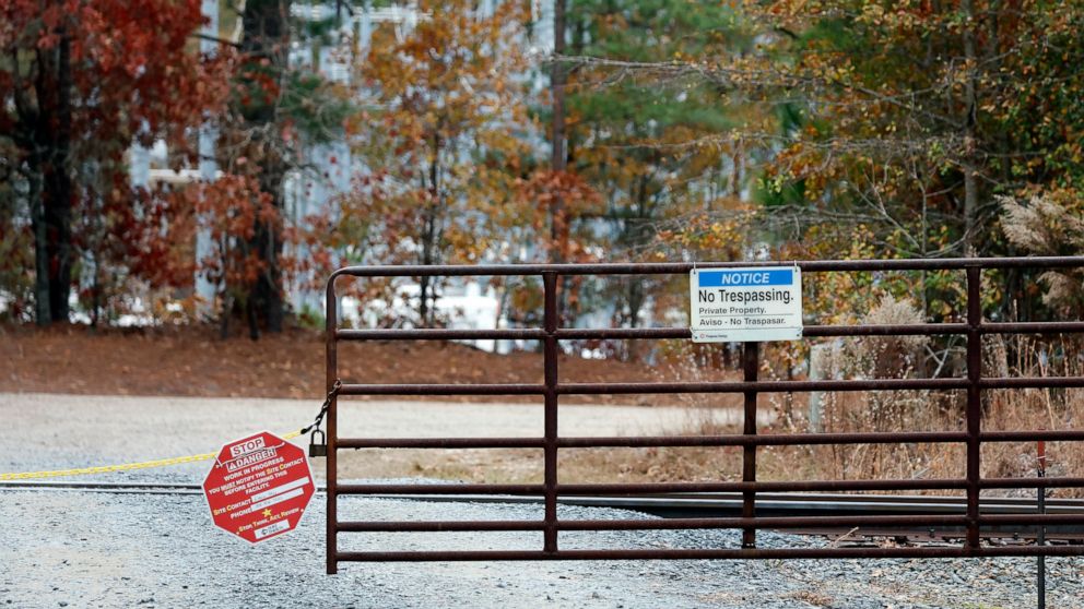 A gate blocks the road leading to the West End Substation, at 6910 NC Hwy 211 in West End, N.C., Monday, Dec. 5, 2022, where a serious attack on critical infrastructure has caused a power outage to many around Southern Pines, N.C. (AP Photo/Karl B De