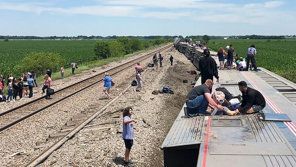 In this photo provided by Dax McDonald, an Amtrak passenger train lies on its side after derailing near Mendon, Mo., on Monday, June 27, 2022. The Southwest Chief, traveling from Los Angeles to Chicago, was carrying about 243 passengers when it colli