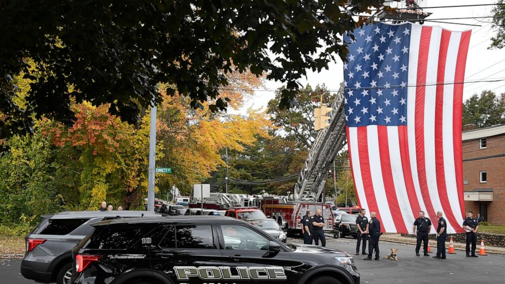 FILE - Police officers from Bristol, Conn. gather with other towns at the scene where two police officers killed, Thursday, Oct. 13, 2022, in Bristol, Conn. The deaths of two Connecticut police officers and the wounding of a third during an especiall
