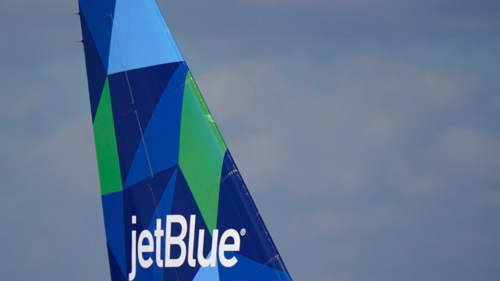FILE - The tail of a JetBlue Airways Airbus A321 is shown as the plane prepares to take off from Fort Lauderdale-Hollywood International Airport, Tuesday, Jan. 19, 2021, in Fort Lauderdale, Fla. JetBlue is buying Spirit Airlines, Thursday, July 28, 2