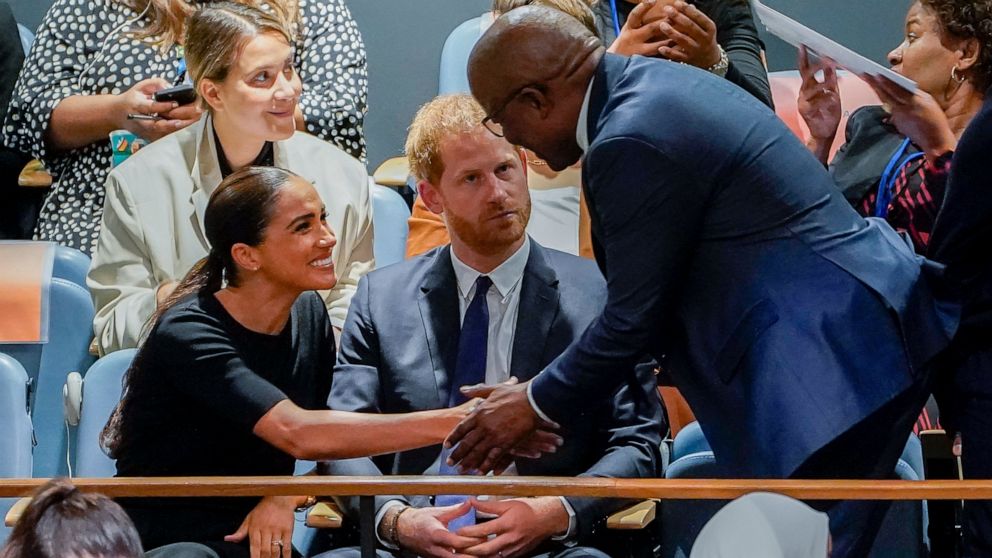 Meghan, Duchess of Sussex, left, shakes hands with Mondli Gungubele, Minister in the Presidency of South Africa, right, alongside Britain's Prince Harry, center, inside the U.N. General Assembly at its annual celebration of Nelson Mandela Internation