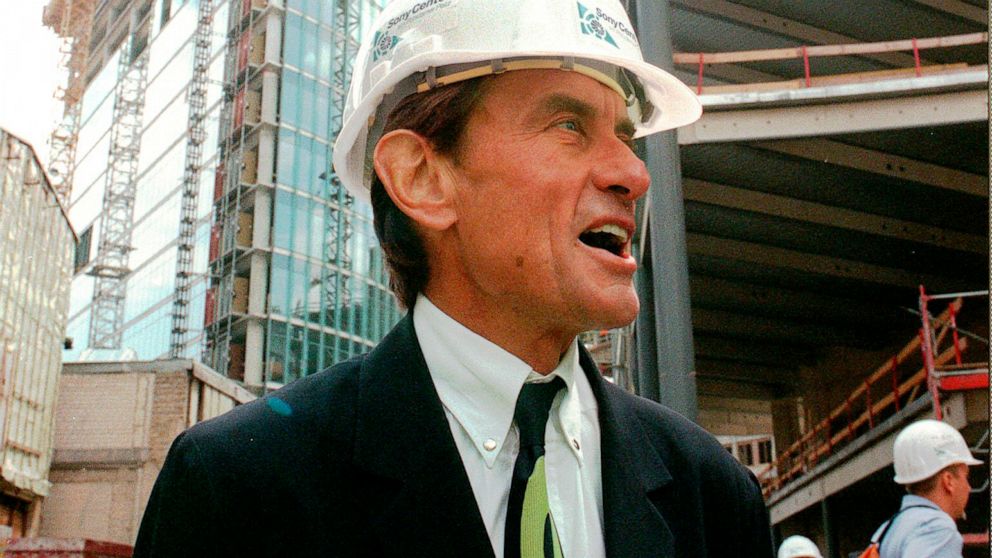 FILE - In this Wednesday, July 15, 1998 file photo, architect Helmut Jahn tours a construction site in Berlin. Jahn, 81, was killed when two vehicles struck the bicycle he was riding on Saturday afternoon, May 8, 2021, while riding north on a village